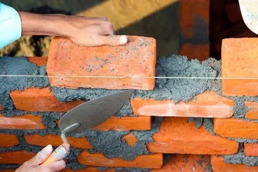 Skilled Indian mason repointing historic wall