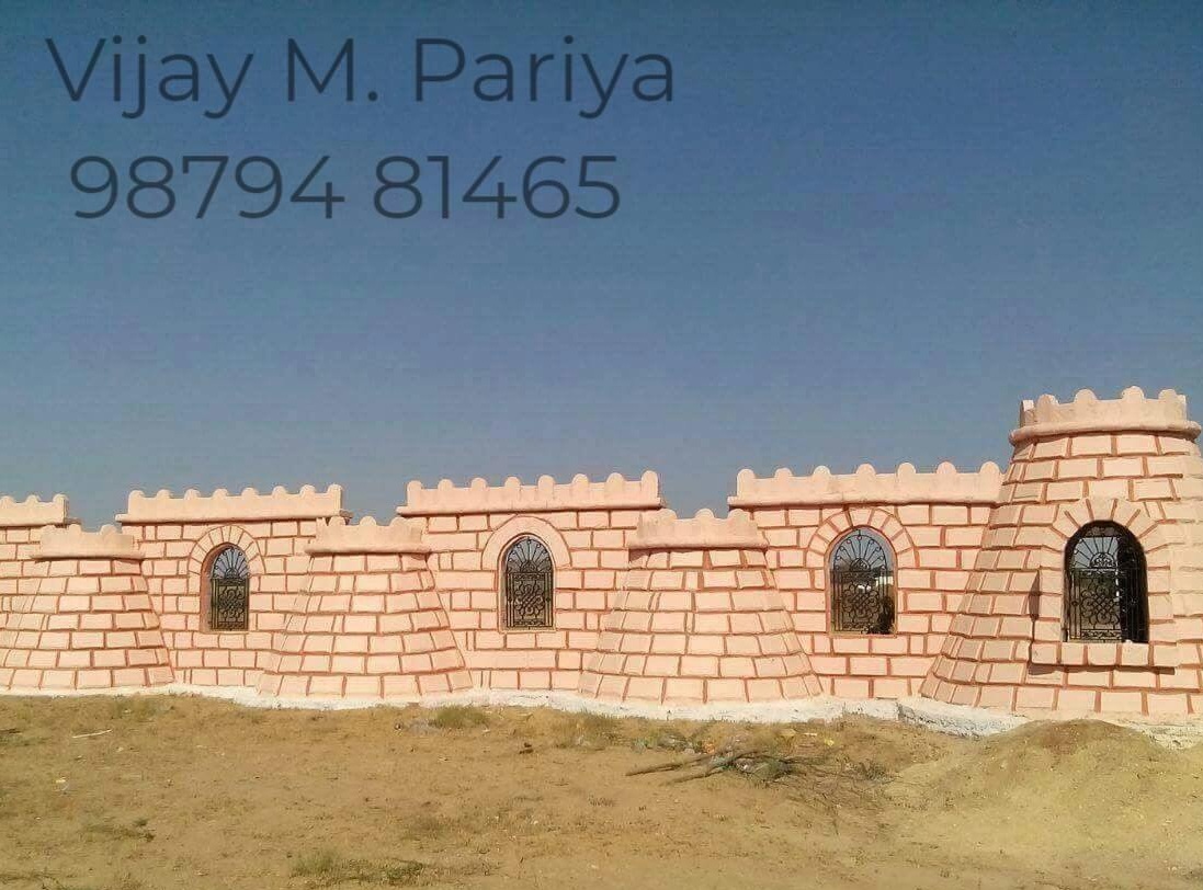 Traditional stone compound wall with intricate detailing