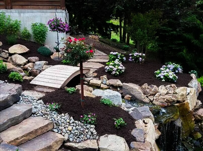 Outdoor seating area with stone pavers and benches